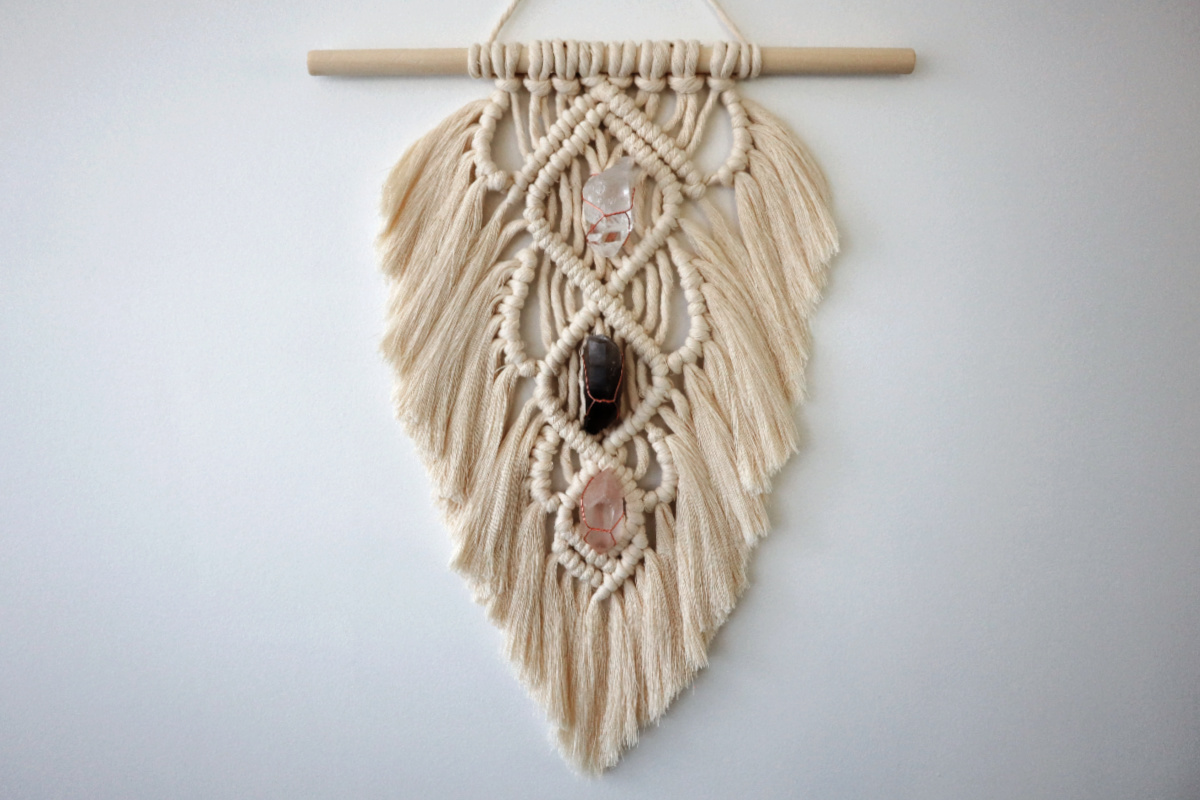 finished macrame feather wall hanging