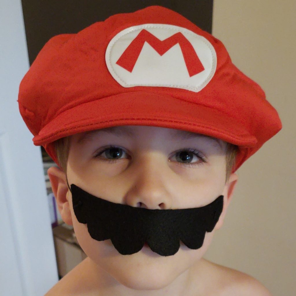cute boy modeling Mario mustache