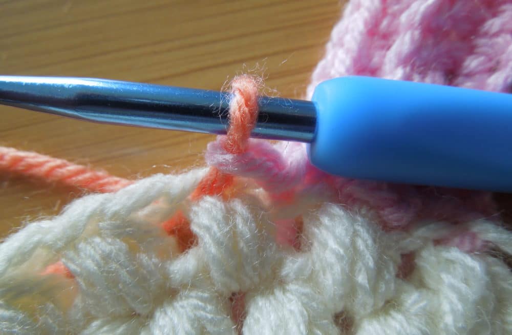 Slip Stitch into next stitch on hat and pull up loop of the next color