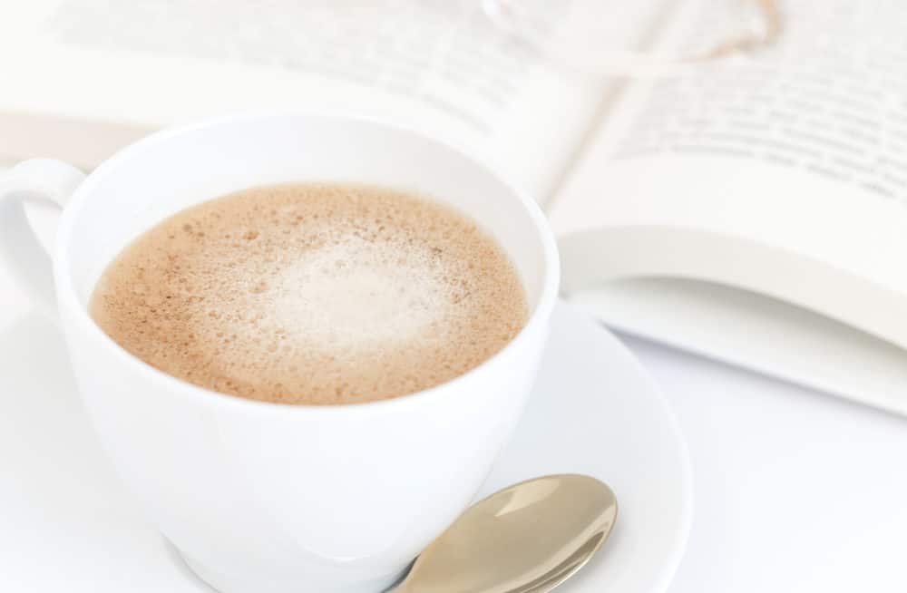 Cup of Coffee next to a book and glasses | best Keurig alternative