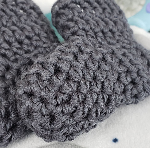 Closeup of crochet baby booties | Marching North
