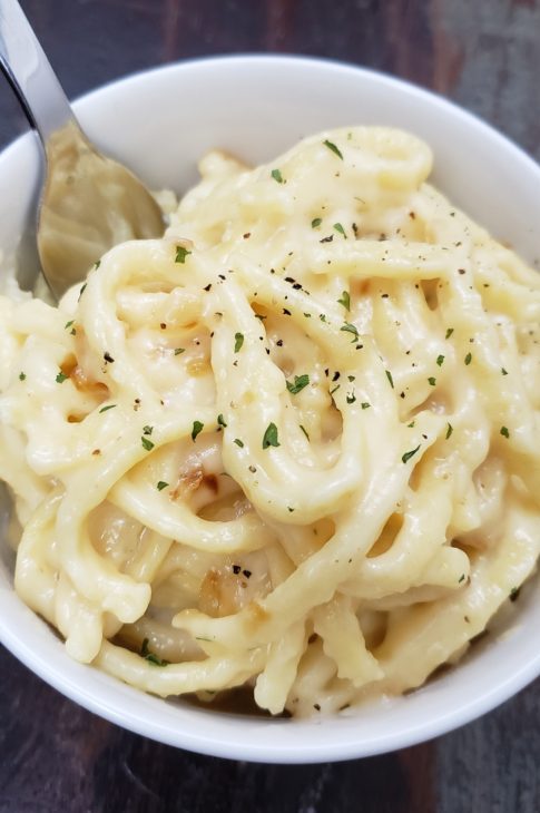 Bowl of cheesy Aldi Spaetzle with caramelized onions | Marching North