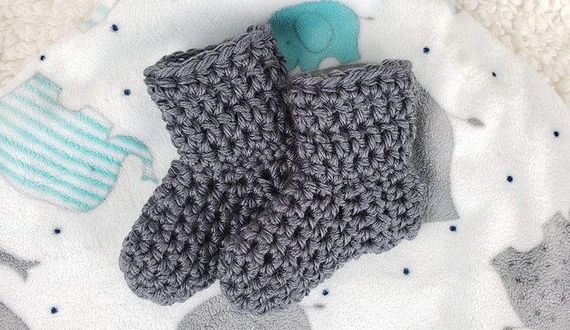Simple Crochet Baby Booties on a baby blanket
