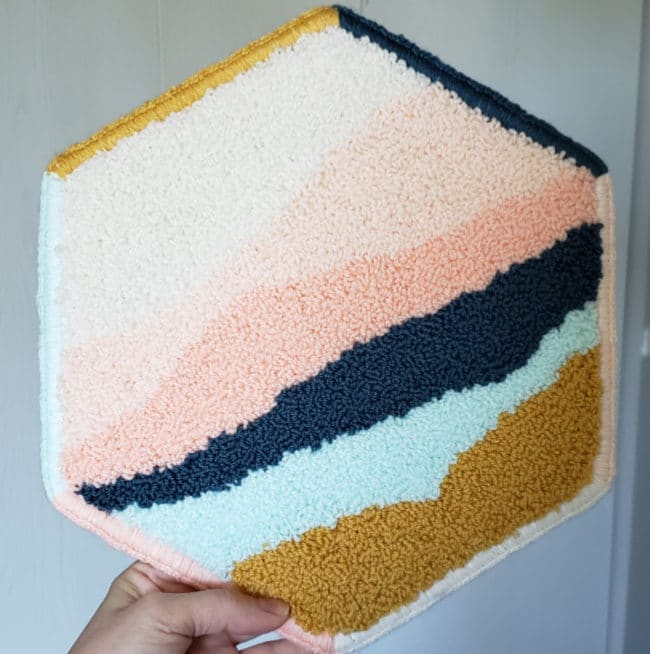hexagon shaped punch needle wall hanging with multiple colors