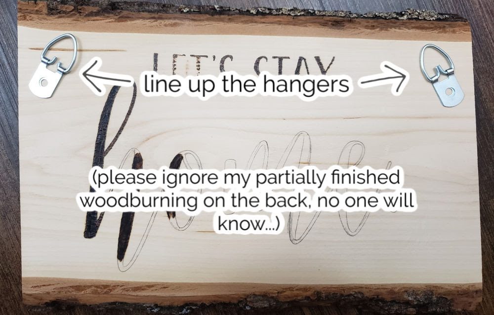 lining up hangers on the back | DIY wood sign | Marching North