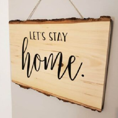rustic wood sign made with Cricut iron on hanging on the wall