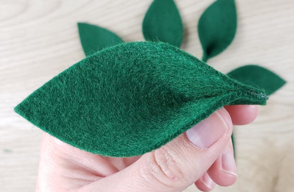 Gluing leaf bottoms together DIY Christmas wreath