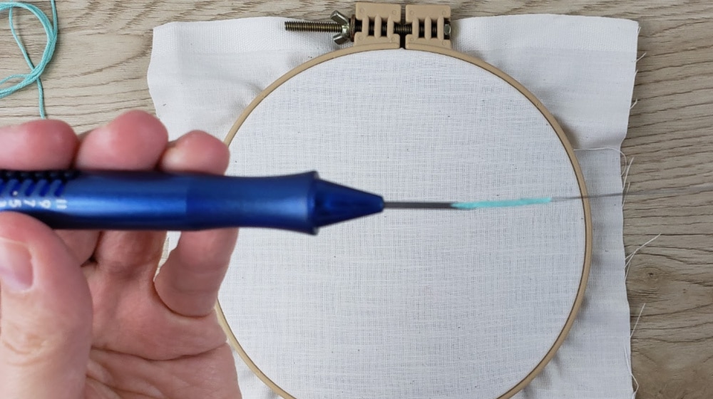 Pull embroidery thread through the punch needle