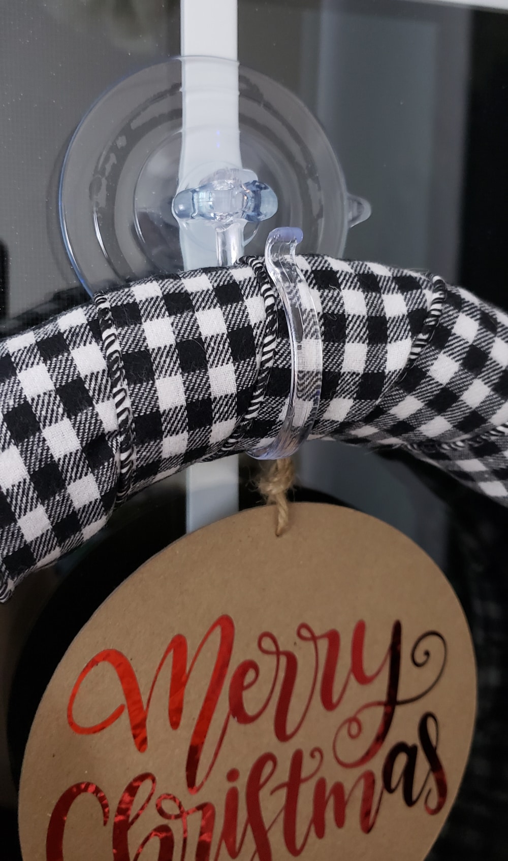 DIY Christmas Wreath secured to the window with a suction cup wreath holder