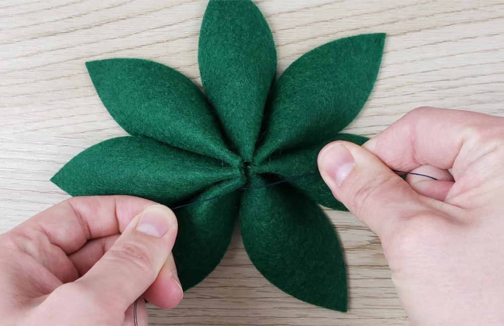 Pull knot nice and tight for DIY Buffalo Plaid and felt holly Christmas Wreath