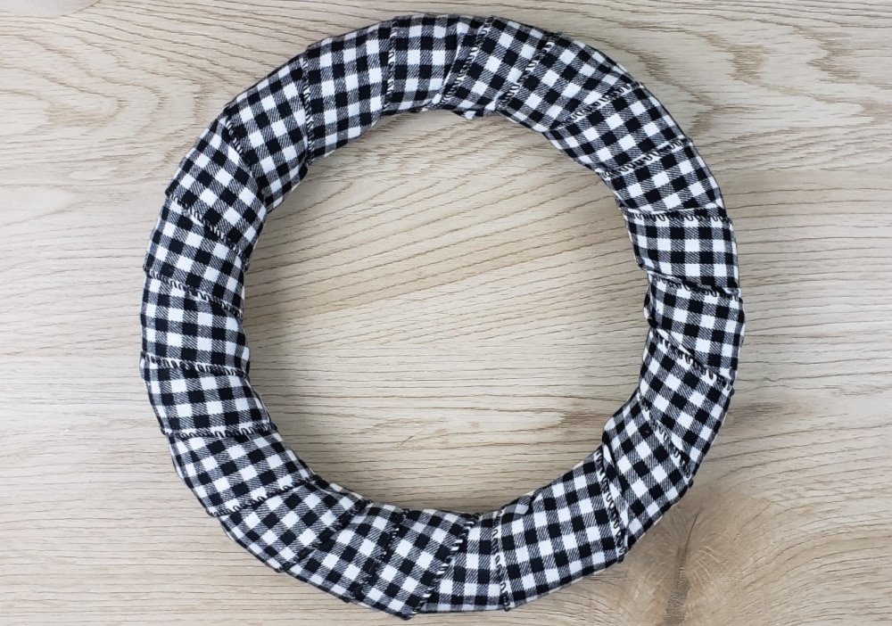 Wreath after wrapping it in buffalo plaid ribbon | DIY Christmas wreath
