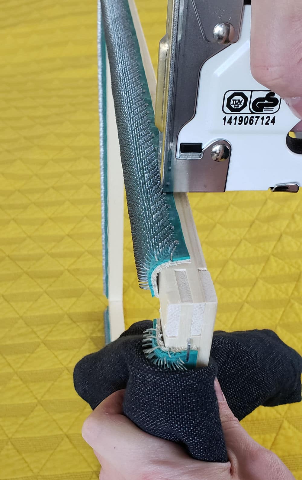 Staple top of gripper strip to frame