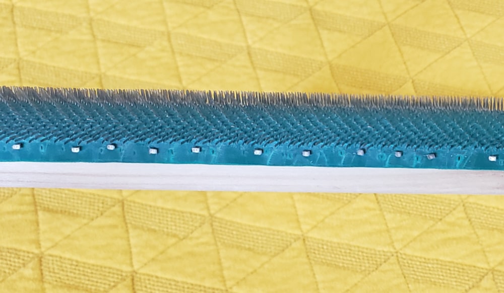Staples placed roughly every half inch on gripper frame