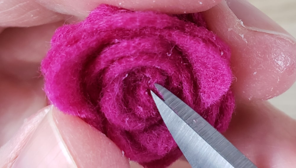 Trimming excess glue off of the felt flower earrings