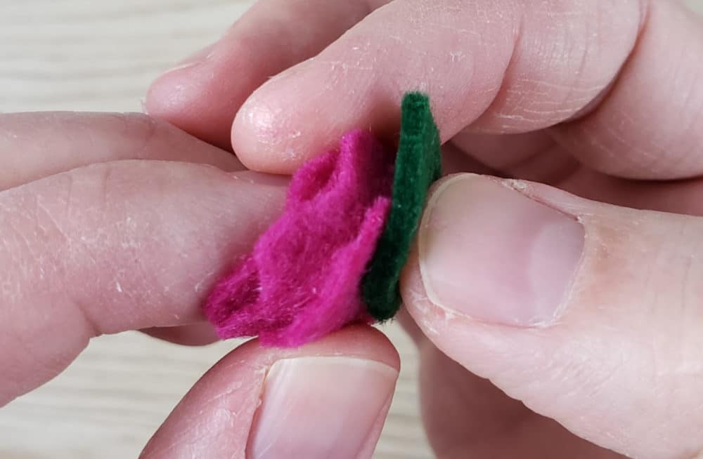 Gluing on the leaf for the felt flower