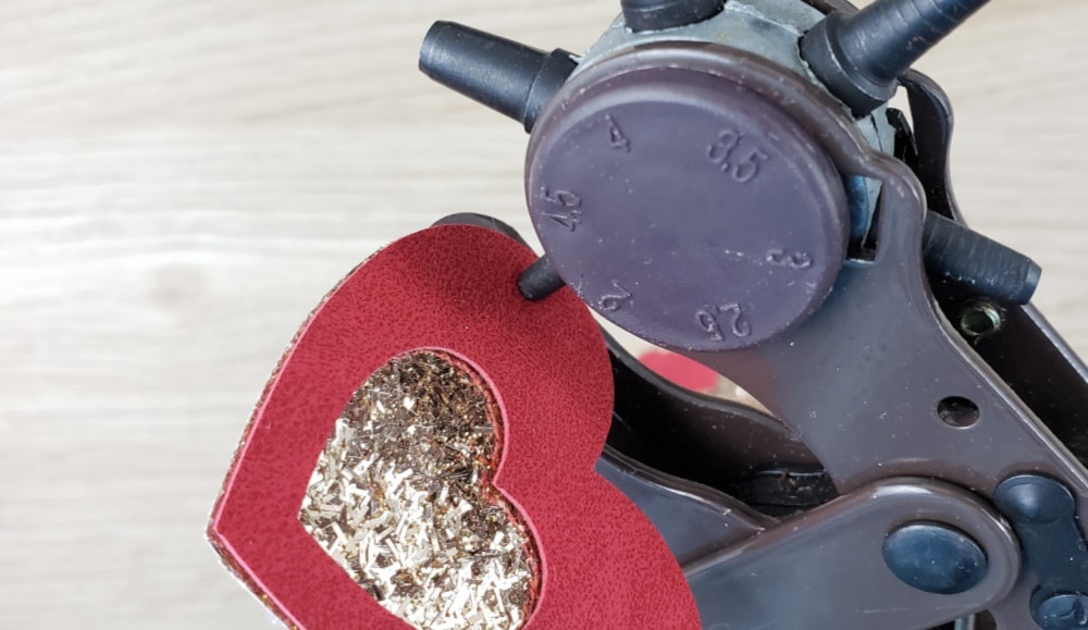 Use leather hole punch to punch holes in faux leather earrings