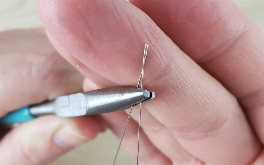Using pliers to bend wire more