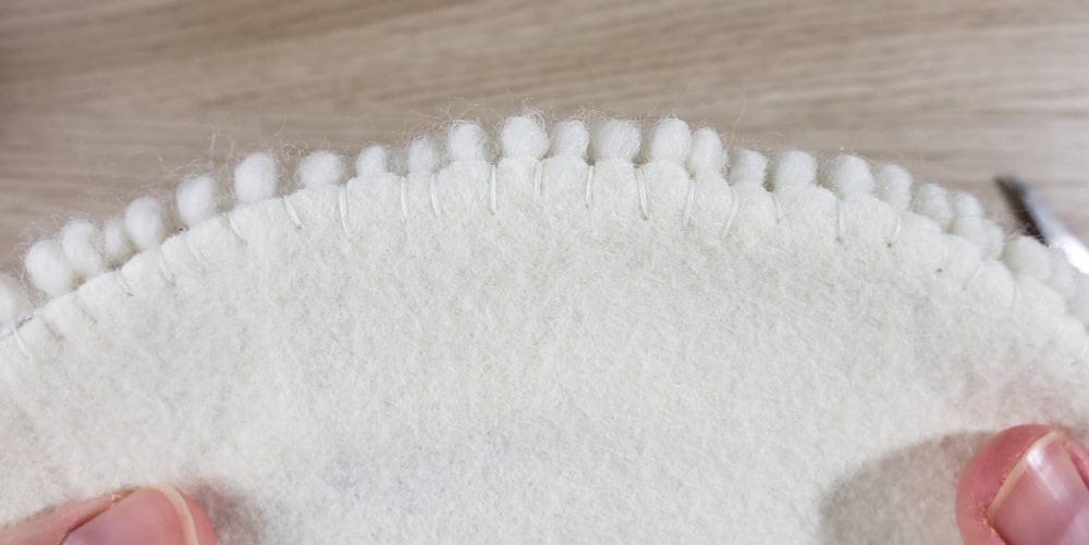 Sewn edge of punch needle trivet
