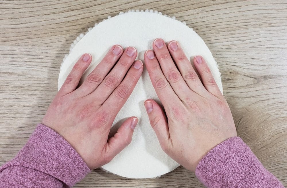 Press the felt circle on the back of the trivet