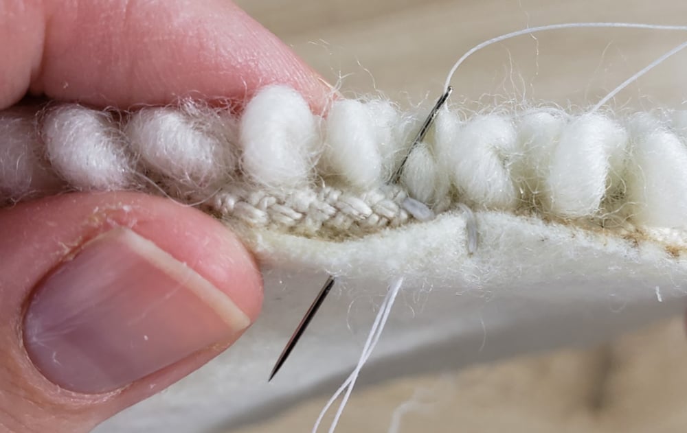 Whip stitch around the edge of the punch needle trivet