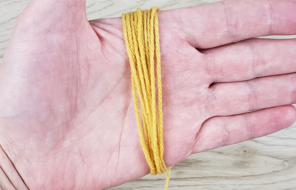 Wrap the yarn around your hand for DIY yarn tassels
