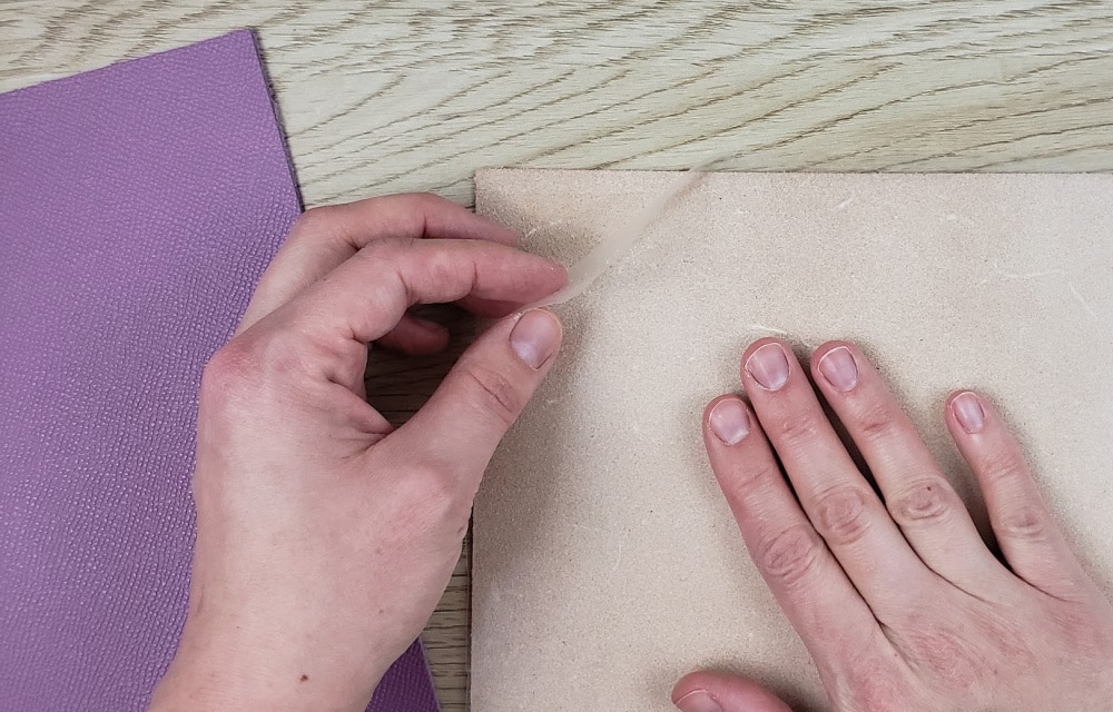 Apply contact paper to the back of the tooling leather