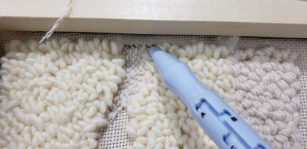 Using a different punch needle on the wall hanging for texture