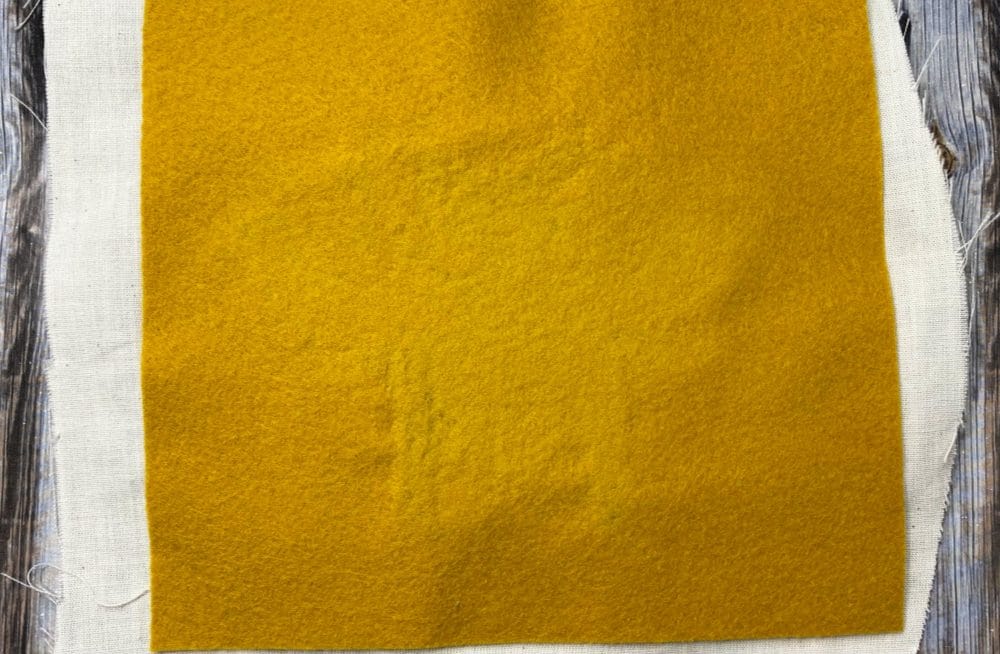 apply felt to the back of the punch needle bee design