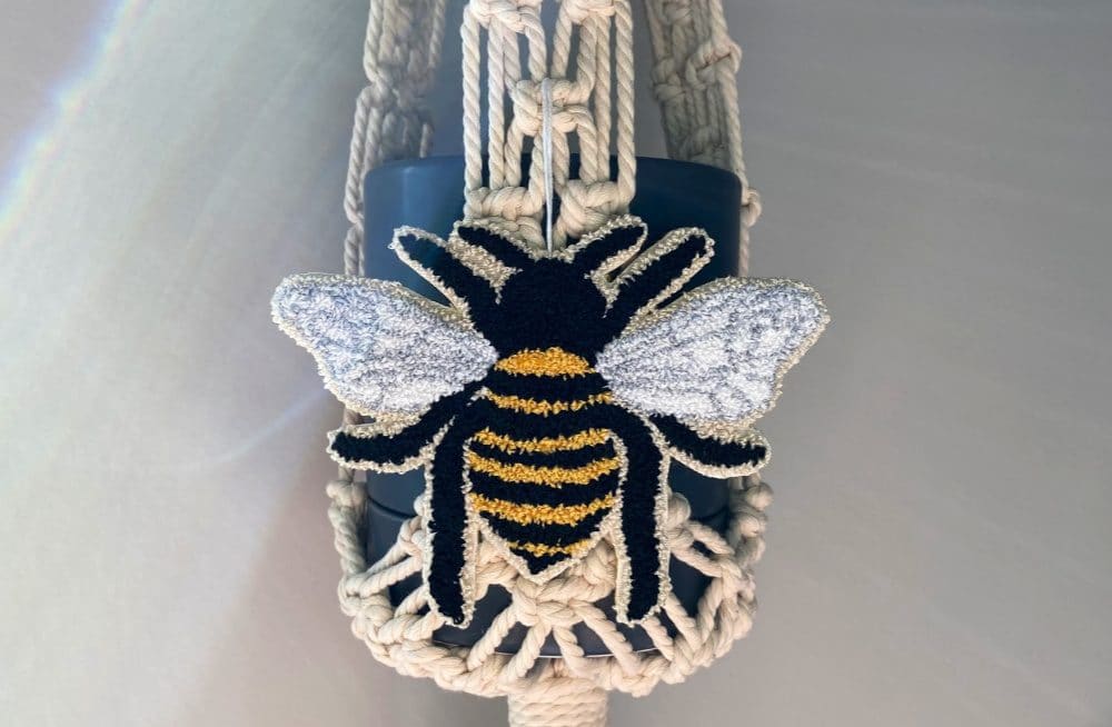 Queen Bee free punch needle pattern on macrame plant hanger