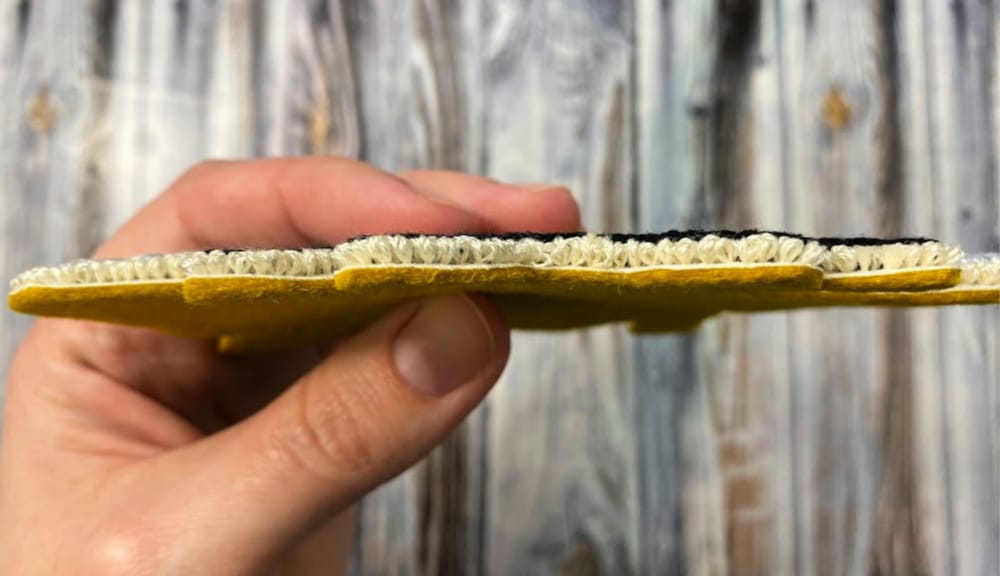 Side view of cut out punch needle bee