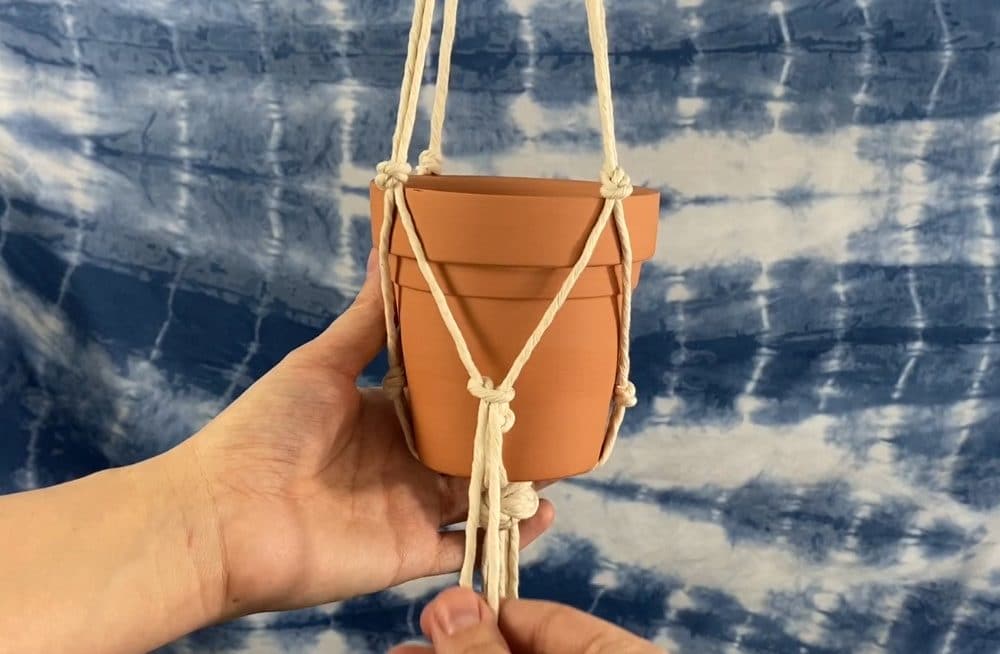 tie a rya knot over the bottom overhand knots | macrame plant hanger tutorial