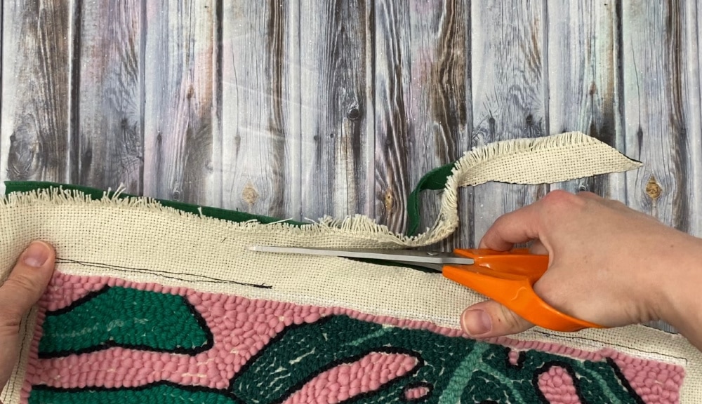 cutting excess fabric off of punch needle pillow