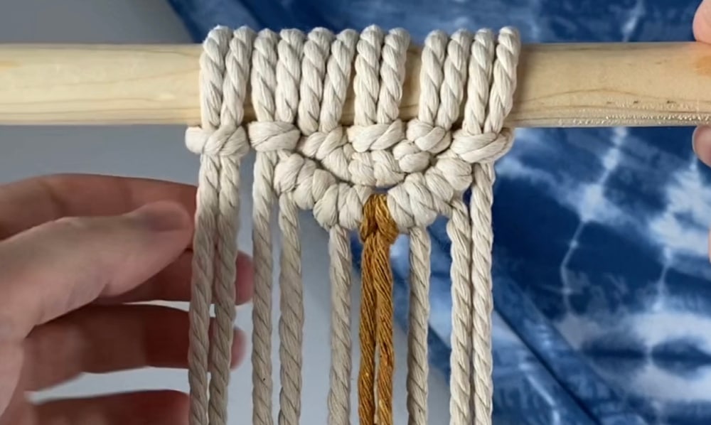 Add the next piece of rope on the left with a larks head knot