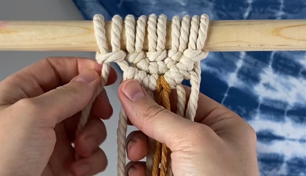 Attach the filler cord to the dowel with a larks head knot