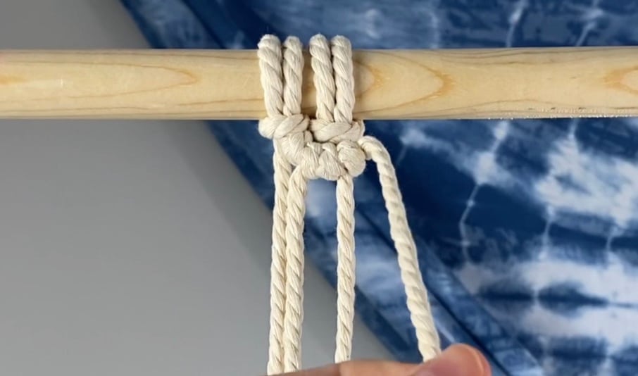 Tie two double half hitch knots to the right