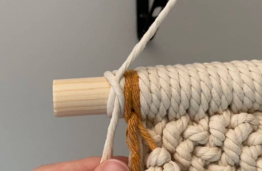 Constrictor knot to hold hanger on DIY macrame wall hanging