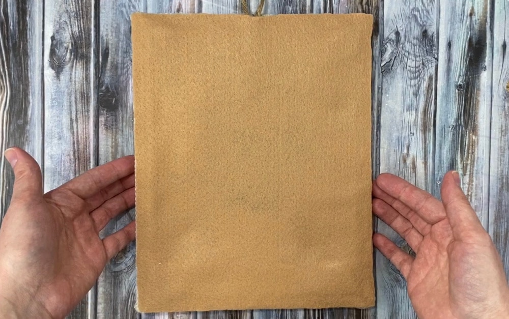 Finished punch needle project on wooden frame