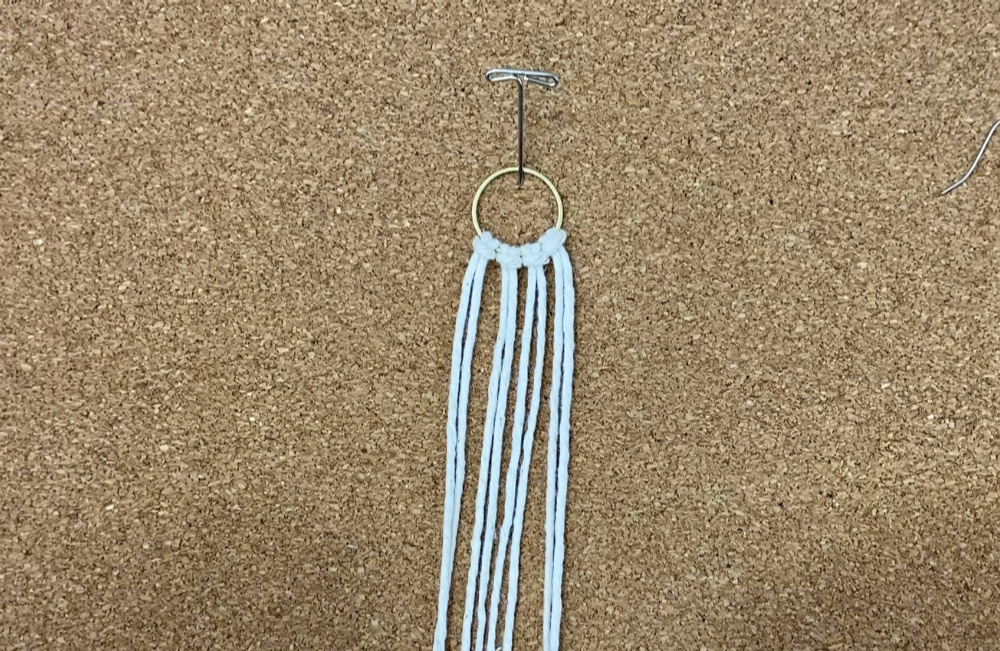 Attach strings with larks head knots | DIY macrame earrings