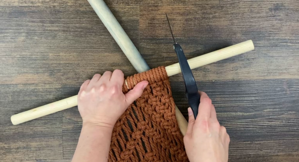 Carefully cut the dowel with the hacksaw