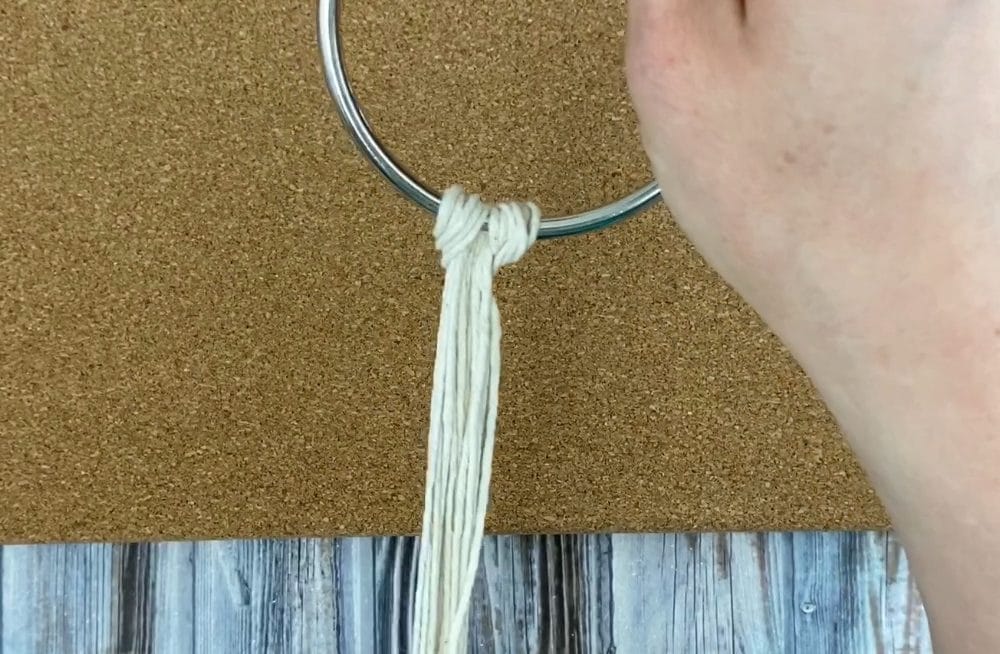 attach the cords to the ring with a larks head knot | mini macrame plant hanger DIY