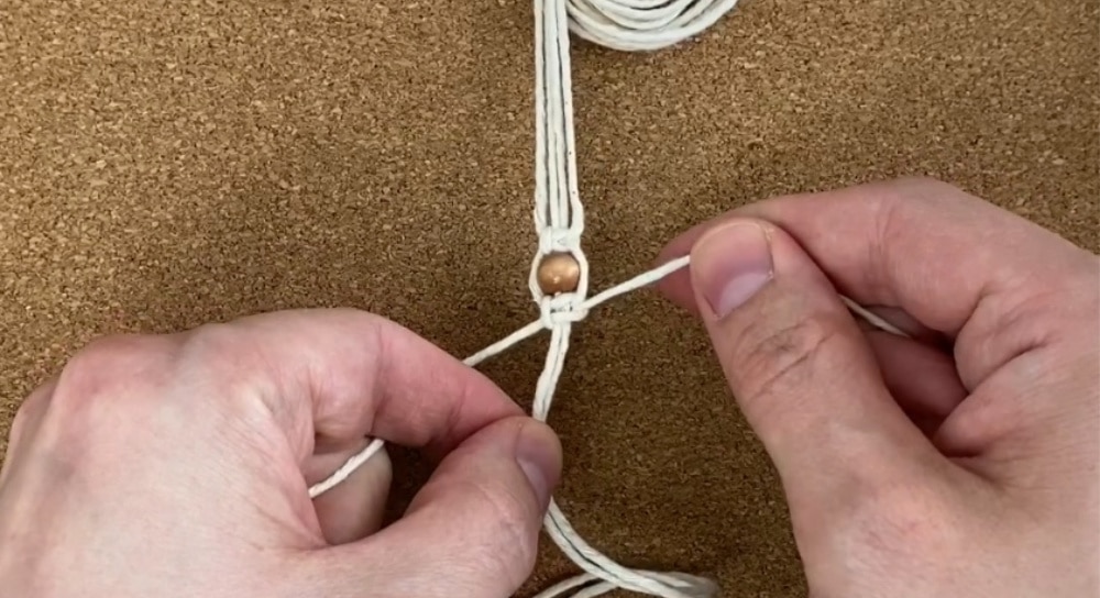 tie another square knot below the bead