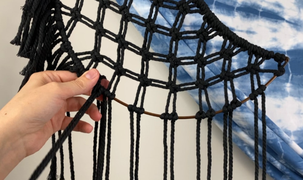 Attaching more fringe to the bottom of the macrame dream catcher