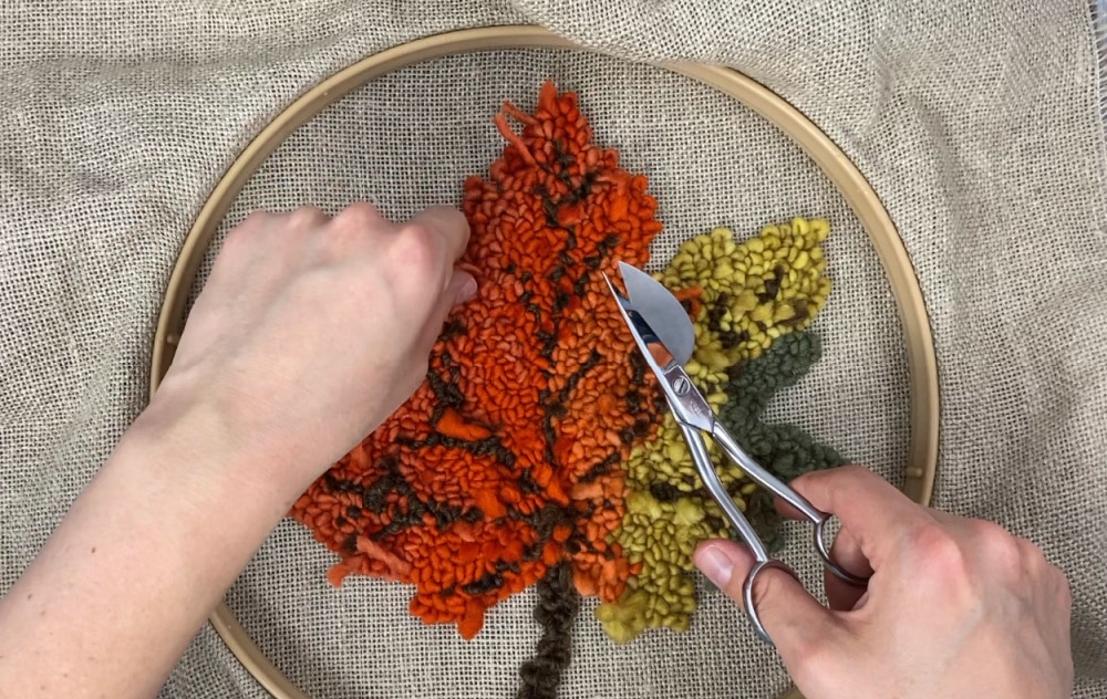 trimming up the back of the maple leaf punch needle project