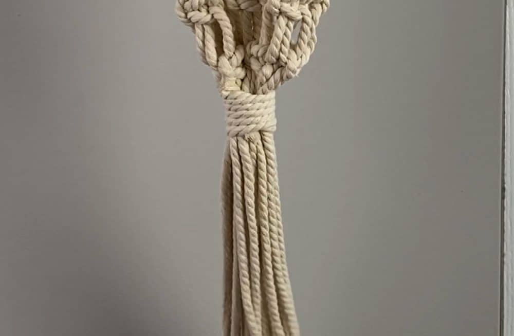 finish the macrame wine tote with a wrapping knot