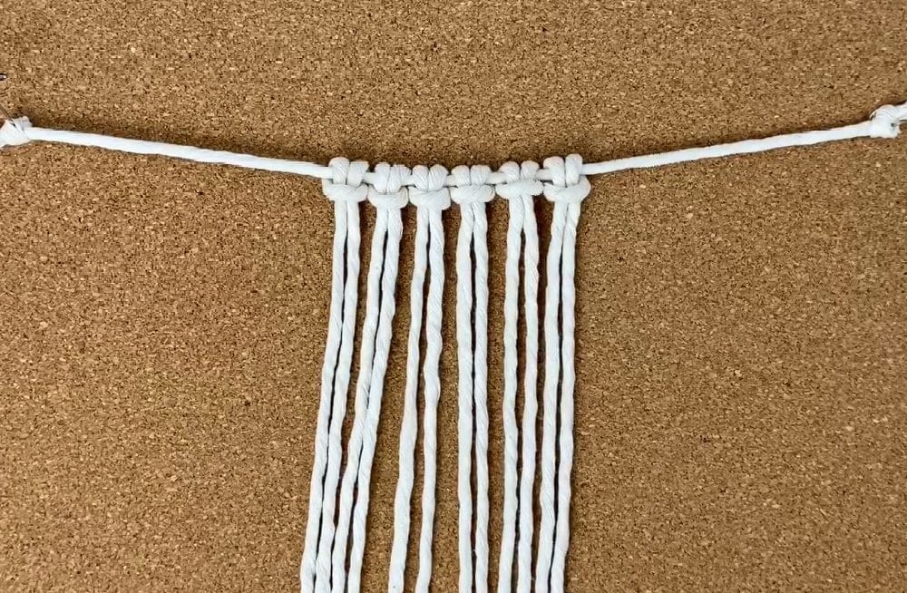attach the working cords with larks head knots | macrame napkin rings