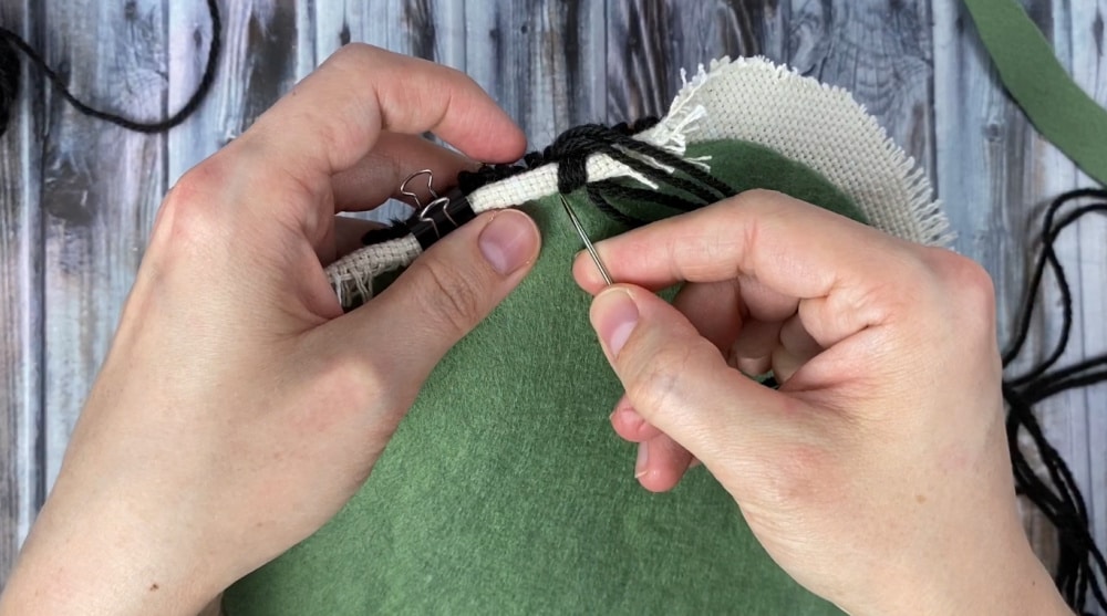 whip stitching the edges of the punch needle trivet