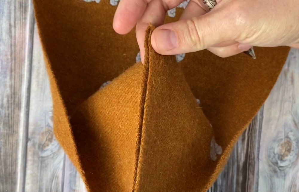 measuring the bottom of the banner to cut the pointed end