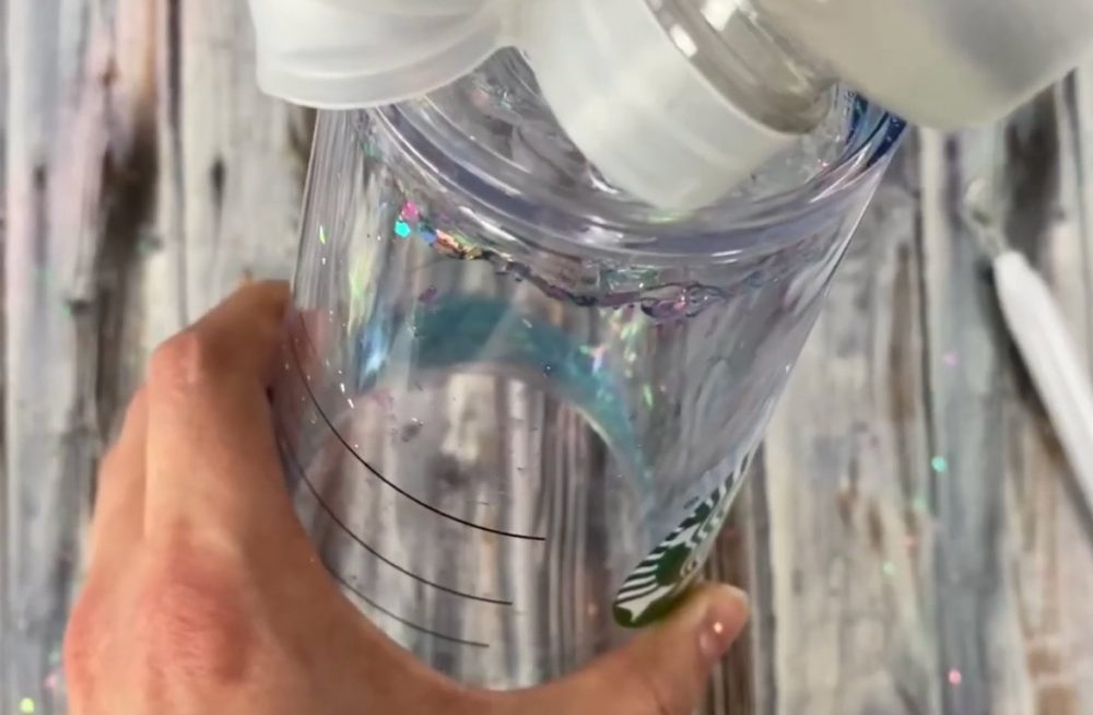 pouring the contact solution into the double walled tumbler