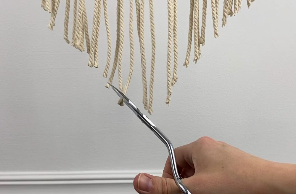 trim the bottom of your small macrame wall hanging into a V shape