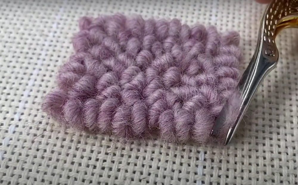 cutting the yarn on the loop side of a punch needle project